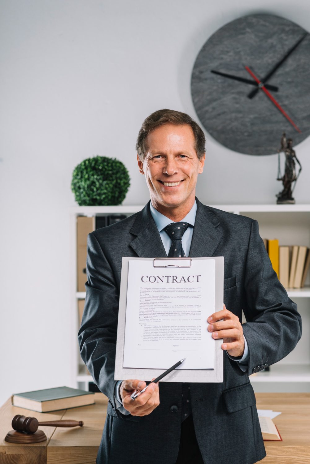 smiling-mature-lawyer-pointing-signature-place-contract-document
